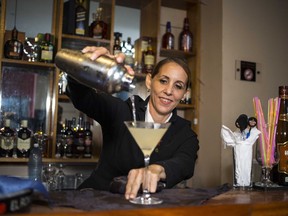 In this Aug. 27, 2018 photo, Cuban bartender Barbara Betancourt Bernal pours a daiquiri at a bar in Havana, Cuba. Known to friends and family as Barbarita, the 46-year-old's career spans two decades.