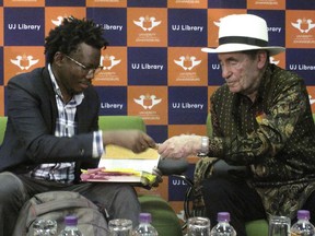 South African lawyer Tembeka Ngcukaitobi, left, and former South African judge Albie Sachs sit together during a speaking event on Tuesday, Sept. 25, 2018, at the University of Johannesburg. The two men discussed anti-apartheid leader Nelson Mandela, who was honored at the United Nations this week with the unveiling of a statue.