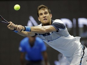 Martin Klizan of Slovakia returns the ball to Stan Wawrinka of Switzerland during the St. Petersburg Open ATP tennis tournament semi final match in St.Petersburg, Russia, Saturday, Sept. 22, 2018.