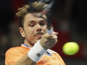 Stan Wawrinka of Switzerland returns the ball to Karen Khachanov of Russia during the St. Petersburg Open ATP tennis tournament match in St.Petersburg, Russia, Wednesday, Sept. 19, 2018.