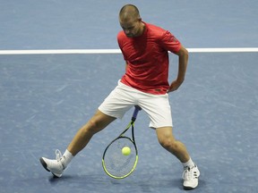 Mikhail Youzhny of Russia returns the ball to Mirza Basic of Bosnia and Herzegovina during the St. Petersburg Open ATP tennis tournament match in St.Petersburg, Russia, Wednesday, Sept. 19, 2018.