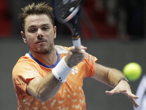 Stan Wawrinka of Switzerland returns the ball to Damir Dzumhur of Bosnia and Herzegovina during the St. Petersburg Open ATP tennis tournament quarter final match in St.Petersburg, Russia, Friday, Sept. 21, 2018.