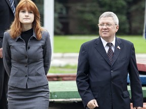In this photo taken on Friday, Sept. 7, 2012, Maria Butina walks with Alexander Torshin then a member of the Russian upper house of parliament in Moscow, Russia. When gun activist Maria Butina arrived in Washington in 2014 to network with the NRA, she was peddling a Russian gun rights movement that was already dead. Fellow gun enthusiasts and arms industry officials describe the strange trajectory of her Russian gun lobby project, which U.S. prosecutors say was a cover for a Russian influence campaign. Accused of working as a foreign agent, Butina faces a hearing Monday, Sept. 10 in Washington.