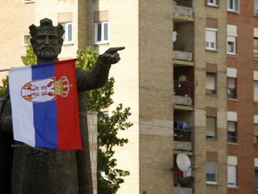 A Serbian flag flutters in front of the monument of late Serbian Duke Lazar  who was killed in the Battle of Kosovo in June 1389, in the northern, Serb-dominated part of Mitrovica, Kosovo, Friday, Sept. 7, 2018. The idea of ​​a "land swap" between Serbia and Kosovo to resolve their long-running dispute once and for all has stirred passions ahead of a new round of talks between former war foes.