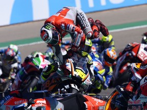 Spain's rider Jorge Lorenzo of the Ducati Team, center top, falls from his bike at the MotoGP race during the Aragon Motorcycle Grand Prix at the Aragon Motorland racetrack in Alcaniz, Spain, Sunday, Sept. 23, 2018.