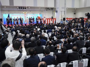 Tokyo Governor Yuriko Koike, rear center, leads opening ceremony for new site of Tokyo's fish market which will officially open to the public next month, in Tokyo Thursday, Sept. 13, 2018. Tokyo's hugely popular Tsukiji fish market will be closed for up to five years while it is modernized and turned into a food theme park. The fish market's move to Toyosu was originally scheduled for last year but has been delayed due to contamination of underground water at the new complex.