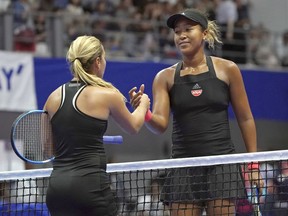 Naomi Osaka, right, of Japan and Dominika Cibulkova, left, of Slovakia greet each other after the second round match of Pan Pacific Open women's tennis tournament in Tokyo Wednesday, Sept. 19, 2018.