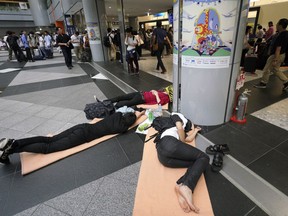 Stranded passengers wait for their flights at Chitose airport in Chitose, Hokkaido, northern Japan,  Saturday, Sept. 8, 2018. The regional airport was beginning to resume operations after hundreds of flights had been cancelled, stranding thousands of travelers, due to Thursday's power outage and light quake damage.