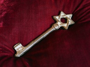An old metal synagogue key discovered at an open-air street market in Lviv is presented at a ceremony commemorating the 75th anniversary of the annihilation of the city's Jewish population by Nazi Germany in Lviv, Ukraine, Sunday, Sept. 2, 2018. The Ukrainian city of Lviv, once a major center of Jewish life in Eastern Europe, is commemorating the 75th anniversary of the annihilation of the city's Jewish population by Nazi Germany and honoring those working today to preserve that vanished world. The commemoration comes amid a larger attempt in Ukraine to preserve the memories of the prewar Jewish community.
