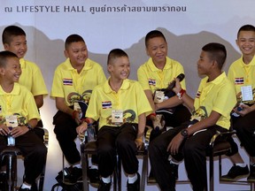 Members of the Wild Boars soccer team laugh during a public discussion in Bangkok, Thailand, Thursday, Sept. 6, 2018. They spoke Thursday at an exhibition about their ordeal of being trapped for almost three weeks in a flooded cave, at one of Bangkok's largest shopping malls.