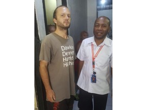 In this undated photo released by Papua representative office of the National Human Rights Commission, Polish national Jakub Skrzypski, left, who is detained and charged with treason on accusation of assisting Papuan independence supporters and separatist fighters talks with the head of Papua Representative Office of the National Human Rights Commission Frits Ramandey, right, at his detention house at the regional police headquarters in Jayapura, Papua province, Indonesia. Skrzypski was arrested in Wamena in Papua province in late August along with four Papuans that police said had ammunition and described as linked to "armed criminal groups," authorities' usual description of Papuan independence fighters. The 39-year-old factory worker faces up to 20 years in prison if he's found guilty. (Papua Representative Office of the National Human Rights Commission via AP)