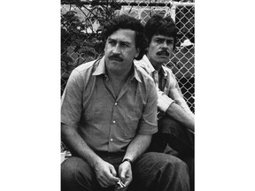FILE - In this 1983 file photo, Medellin drug cartel boss Pablo Escobar watches a soccer game in Medellin, Colombia. Colombian police announced Thursday, Sept. 20, 2018 that they have shut down a small makeshift museum that showcased the life and times of notorious drug lord, saying the building's managers do not have a tourism license.  The site was managed by Escobar's 71-year-old brother, Roberto. (AP Photo, File)
