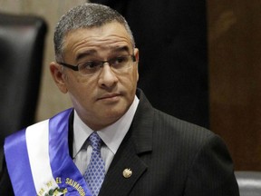 FILE - In this June 1, 2012 file photo, El Salvador's President Mauricio Funes stands in the National Assembly before speaking to commemorate the anniversary of his third year in office in San Salvador, El Salvador. Prosecutors in El Salvador are seeking on Friday, Sept. 14, 2018, the extradition of former President Mauricio Funes and three family members on corruption charges. Funes, the relatives and ex-officials are accused in connection the alleged embezzlement of $351 million in public funds.
