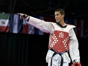 FILE - In this July 21, 2015 file photo, United States' Steven Lopez celebrates winning a bronze medal by defeating Venezuela's Javier Medina in the men's taekwondo under-80kg category at the Pan Am Games in Mississauga, Ontario. The U.S. Center for SafeSport has on Thursday, Sept. 6, 2018, permanently banned the two-time Olympic taekwondo champion for sexual misconduct involving a minor.