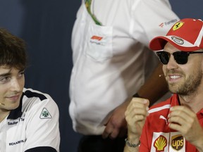 FILE - In this May 23, 2018 file photo, Ferrari driver Sebastian Vettel of Germany, right, is flanked by Sauber driver Charles Leclerc of Monaco during a news conference, at the Monaco racetrack, in Monaco. Kimi Raikkonen is leaving Ferrari for Sauber and will be replaced by rookie Charles Leclerc, that will team up with Sebastian Vettel.