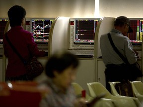 Chinese investors use computer terminals as they monitor stock prices at a brokerage house in Beijing, Tuesday, Sept. 11, 2018. Asian stocks were mixed Tuesday after Wall Street's gains as investors waited for a new U.S. tariff hike in a trade battle with China.
