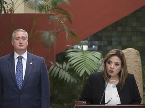 Foreign Minister Sandra Jovel, right, gives a press conference accompanied by Interior Minister Enrique Degenhart, in Guatemala City, Monday, Sept. 17, 2018. The Guatemalan government will defy a ruling by the country's top court and block the return of Ivan Velasquez, who is leading a U.N.-backed anti-corruption commission.