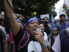 Demonstrators march against Guatemalan President Jimmy Morales and in support of the fight against corruption in Guatemala City, Friday, Sept. 14, 2018. President Morales had announced that he would not renew the U.N.-backed commission investigating corruption in the country for another two-year mandate, giving the commission until the end of its current term in September 2019 to transfer all its functions to Guatemalan institutions.