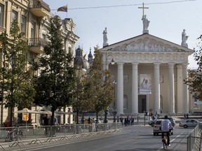 A photo of Pope Francis is hung in front of the Cathedral Basilica of St Stanislaus and St Ladislaus in Vilnius, Lithuania, Friday, Sept. 21, 2018, ahead of Pope Francis' upcoming visit to Lithuania. Pope Francis heads to Europe's northeastern peripheries this weekend to celebrate the faith in three Baltic countries amid renewed alarm about Russia's intentions in the region it twice occupied.