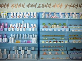 ADDS TRANSLATION - Products made by the Pyongyang Cosmetics Factory are on display in Pyongyang, North Korea, Saturday, Sept. 8, 2018. The Pyongyang Cosmetics Factory, which was recently renovated, is one of the North's main producers of cosmetic items. The Korean words mean "Compete with the world, challenge the world, go lead the world!"