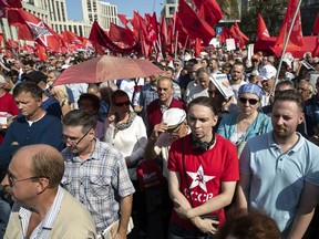 People attend the Communist Party rally protesting retirement age hikes in Moscow, Russia, Sunday, Sept. 2, 2018. Several thousand people gathered in central Moscow on Sunday for a protest organized by the Communist Party and other demonstrations were reported in Vladivostok in the Far East and Barnaul and Novosibirsk in Siberia.