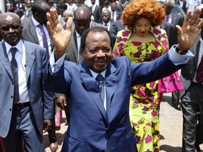 FILE - In this Sunday Oct 9, 2011 file photo, Cameroon President Paul Biya waves after casting his vote during the presidential elections in Yaounde, Cameroon. A bloody conflict between Cameroon's government and Anglophone separatists over language is now threatening next month's presidential election. The 85-year-old President Paul Biya, one of Africa's longest-serving leaders, vows to hold the largely Francophone country together even as thousands flee violence in English-speaking regions.