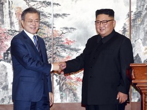 South Korean President Moon Jae-in, left, and North Korean leader Kim Jong Un shake hands after signing the documents in Pyongyang, North Korea, Wednesday, Sept. 19, 2018. Moon and Kim announced a sweeping set of agreements after their second day of talks in Pyongyang on Wednesday that included a promise by Kim to permanently dismantle the North's main nuclear complex if the United States takes corresponding measures, the acceptance of international inspectors to monitor the closing of a key missile test site and launch pad and a vow to work together to host the Summer Olympics in 2032.(Pyongyang Press Corps Pool via AP)