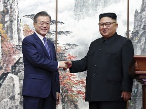 South Korean President Moon Jae-in, left, and North Korean leader Kim Jong Un shake hands during a joint press conference at the Paekhwawon State Guesthouse in Pyongyang, North Korea, Wednesday, Sept. 19, 2018. (Pyongyang Press Corps Pool via AP)