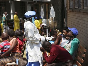 A health worker attends to patients suffering from cholera symptoms at a local hospital in Harare, Tuesday, Sept, 11, 2018.  A cholera emergency has been declared in Zimbabwe's capital after 20 people have died, the health minister said Tuesday.