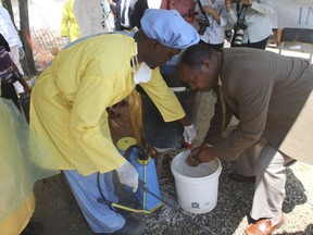 Zimbabwe Health Minister Obadiah Moyo washes his hands before entering a cholera quarantine area in Harare, Friday, Sept. 14, 2018, after a cholera emergency was declared in Zimbabwe's capital following the deaths of more than 20 people.  The deaths in Harare have many fearing a repeat of the outbreak that killed thousands in 2008.