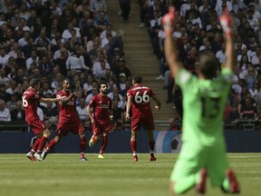 Liverpool's Georginio Wijnaldum, 2nd from left, reacts as he celebrates with team members after scoring his side opening goal during the English Premier League soccer match between Tottenham Hotspur and Liverpool at Wembley Stadium in London, Saturday Sept. 15, 2018.