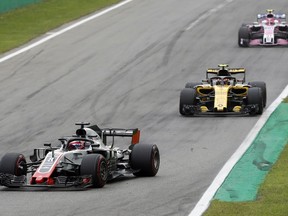 Haas driver Romain Grosjean of France followed by Renault driver Carlos Sainz of Spain and Force India driver Esteban Ocon of France during the Formula One Italy Grand Prix at the Monza racetrack, in Monza, Italy, Sunday, Sept. 2, 2018.