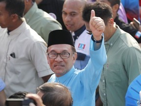 Malaysia's reform icon Anwar Ibrahim waves to his supporters as he arrives for by-election nomination in Port Dickson, Malaysia, Saturday, Sept. 29, 2018. Anwar is contesting by-election in Port Dickson, a southern coastal town after a lawmaker vacated the seat to make way for Anwar Ibrahim's political comeback.