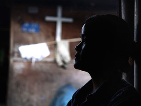 In this March 21, 2018, photo, Marip Lu sits in her family's shelter in a refugee camp in northern Kachin State, Myanmar. Marip Lu, 24, claims she was kidnapped by traffickers and suffered six years of captivity, rape and abuse deep in China. As the demand for "brides" in China rises, The Associated Press has pieced together the tragic ordeal of one woman who escaped, but had to leave her son behind.