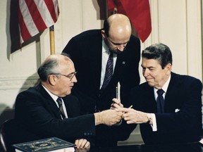 In this Dec. 8, 1987 file photo U.S. President Ronald Reagan, right, and Soviet leader Mikhail Gorbachev exchange pens during the Intermediate Range Nuclear Forces Treaty signing ceremony in the White House East Room in Washington, D.C.