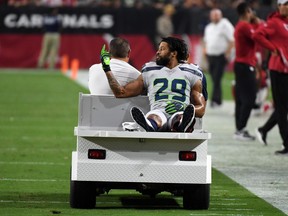 Defensive back Earl Thomas #29 of the Seattle Seahawks gestures as he leaves the field on a cart after being injured during the fourth quarter against the Arizona Cardinals at State Farm Stadium on September 30, 2018 in Glendale, Arizona.