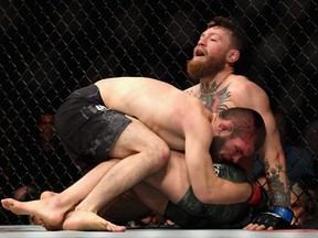 Khabib Nurmagomedov of Russia holds down Conor McGregor of Ireland in their UFC lightweight championship bout during the UFC 229 event inside T-Mobile Arena on October 6, 2018 in Las Vegas, Nevada.