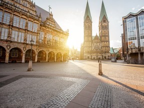 View of the market square with city hall and Saint Peter Cathedral and Haus der Buergerschaft (parliament building) during the morning light in Bremen City, Germany.