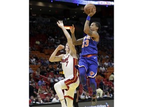 New York Knicks guard Trey Burke (23) drives to the basket as Miami Heat guard Goran Dragic (7) defends during the first half of an NBA basketball game, Wednesday, Oct. 24, 2018, in Miami.