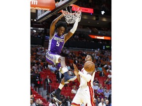 Sacramento Kings guard De'Aaron Fox (5) dunks the ball against Miami Heat center Hassan Whiteside during the first half of an NBA basketball game, Monday, Oct. 29, 2018, in Miami.