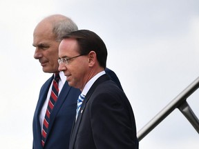 Deputy Attorney General Rod Rosenstein (R) and White House Chief of Staff John Kelly step off Air Force One on October 8, 2018.