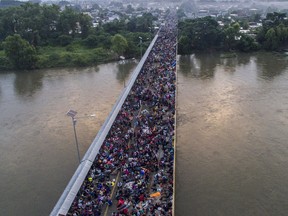 Aerial view of a Honduran migrant caravan heading to the US, on the Guatemala-Mexico international border bridge in Ciudad Hidalgo, Chiapas state, Mexico, on October 20, 2018.