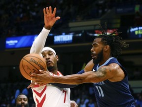 Memphis Grizzlies guard Mike Conley (11) is fouled by Houston Rockets forward Carmelo Anthony (7) as he goes up for a shot during the first half of a preseason NBA basketball game, Tuesday, Oct. 2, 2018, in Birmingham, Ala.