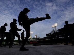 Members of the Houston Astros warm up during batting practice before Game 2 of a baseball American League Championship Series against the Boston Red Sox on Sunday, Oct. 14, 2018, in Boston.