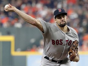 Boston Red Sox starting pitcher Nathan Eovaldi throws against the Houston Astros during the first inning in Game 3 of a baseball American League Championship Series on Tuesday, Oct. 16, 2018, in Houston.