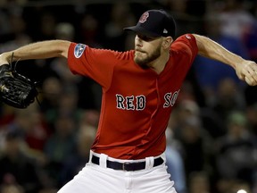 Boston Red Sox starting pitcher Chris Sale throws against the Houston Astros during the first inning in Game 1 of a baseball American League Championship Series on Saturday, Oct. 13, 2018, in Boston.