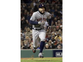 Houston Astros' George Springer runs to first after a two RBI-single against the Boston Red Sox during the second inning in Game 2 of a baseball American League Championship Series on Sunday, Oct. 14, 2018, in Boston.