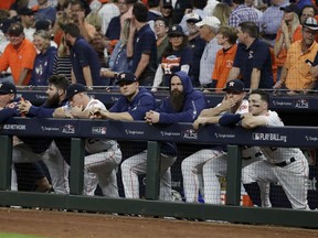 Members of the Houston Astros watch during the ninth inning in Game 5 of a baseball American League Championship Series against the Boston Red Sox on Thursday, Oct. 18, 2018, in Houston.