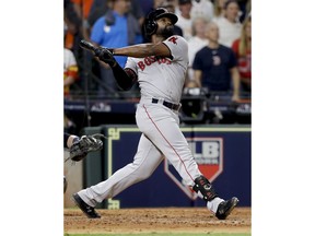 Boston Red Sox's Jackie Bradley Jr. watches his grand slam against the Houston Astros during the eighth inning in Game 3 of a baseball American League Championship Series on Tuesday, Oct. 16, 2018, in Houston.