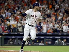 Houston Astros' Carlos Correa celebrates his RBI-single against the Boston Red Sox during the fifth inning in Game 4 of a baseball American League Championship Series on Wednesday, Oct. 17, 2018, in Houston.